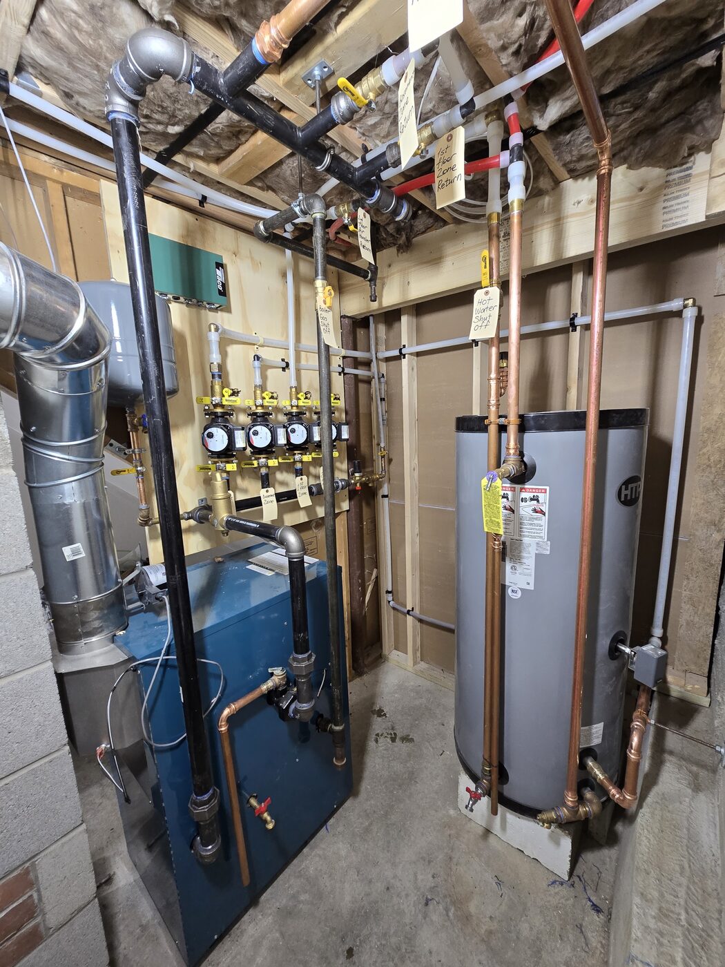 Basement mechanical room with a boiler, indirect water heater and labeled copper piping