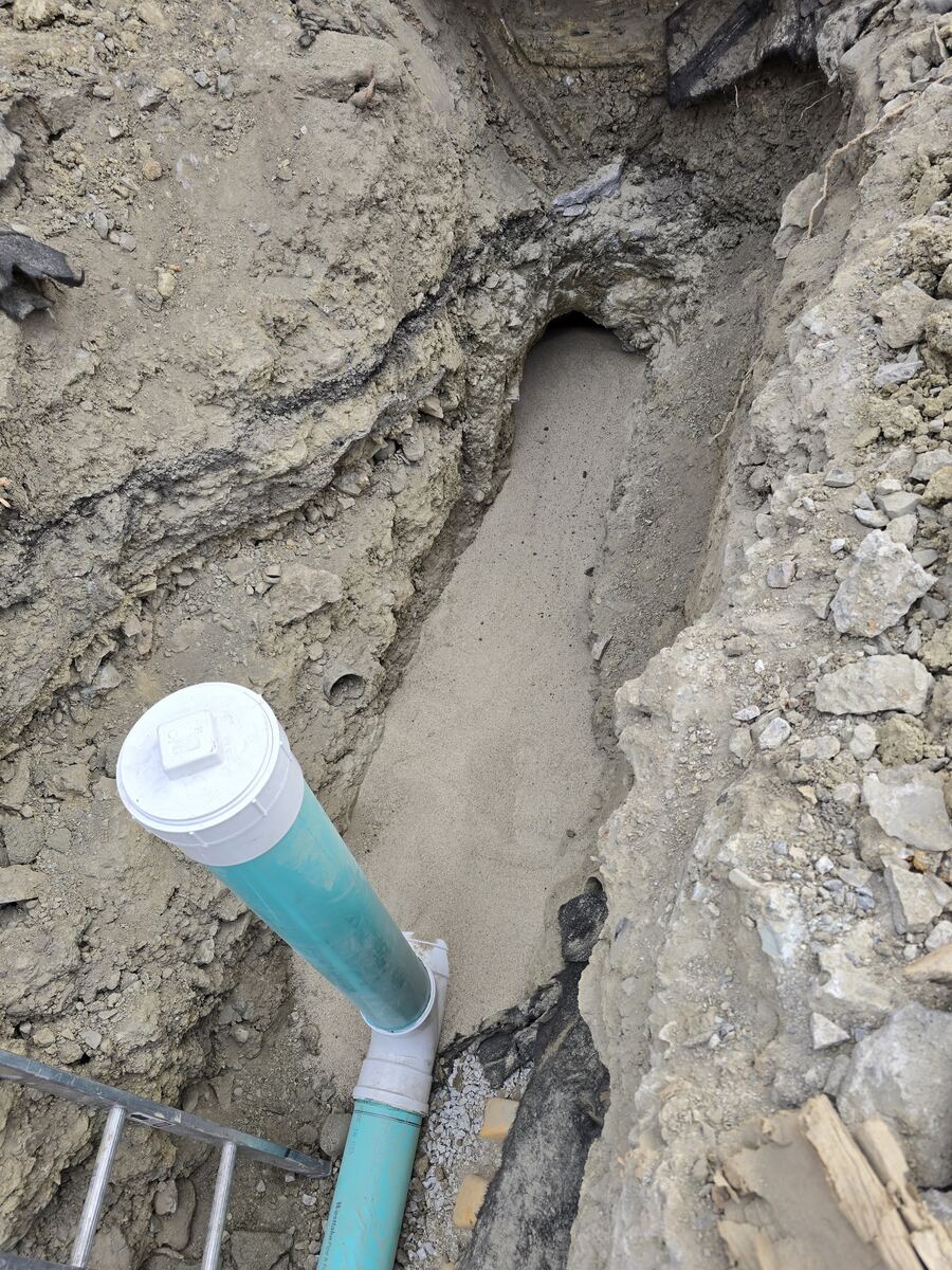 New PVC sewer line laid in an open trench during a sewer replacement