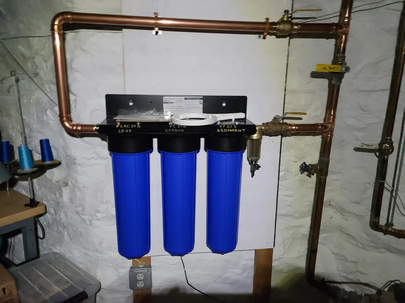 Three-stage whole-house water filter installed on the main line with copper piping and bypass valves by IS Plumbing