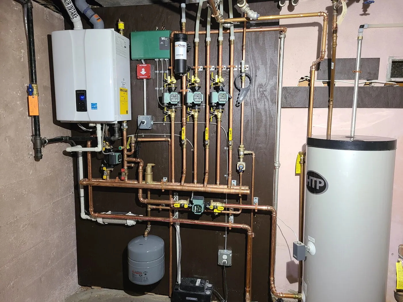 High-efficiency condensing boiler and water heater with copper piping, installed by IS Plumbing in a Greater Boston mechanical room