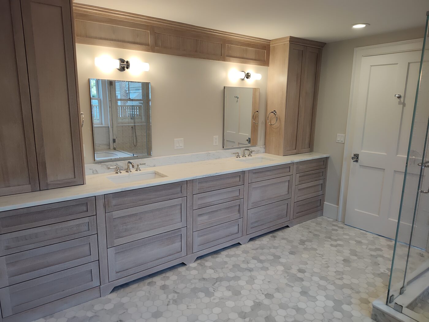 Custom bathroom double vanity with framed mirrors and tile work