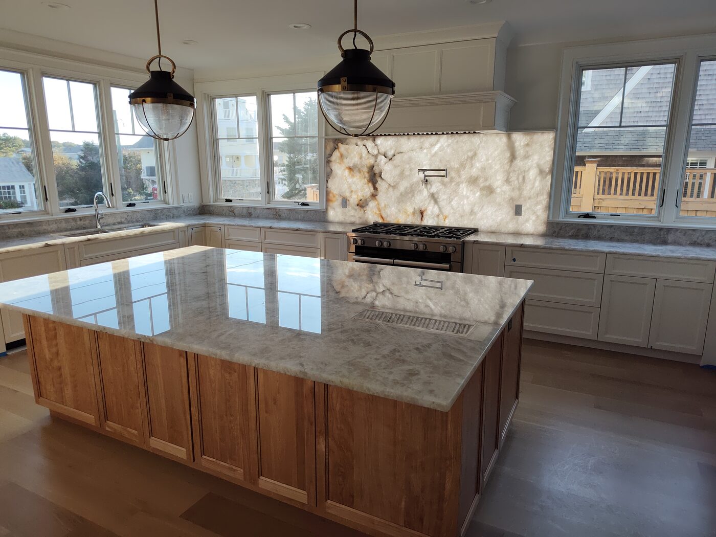 Kitchen island with a quartz countertop and pendant lighting