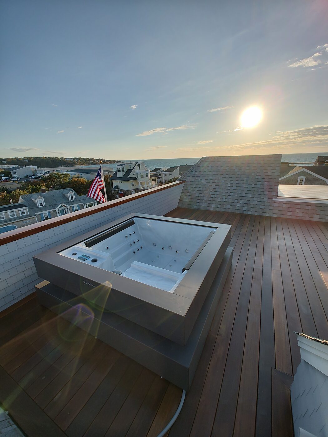 Rooftop deck hot tub installation at sunset