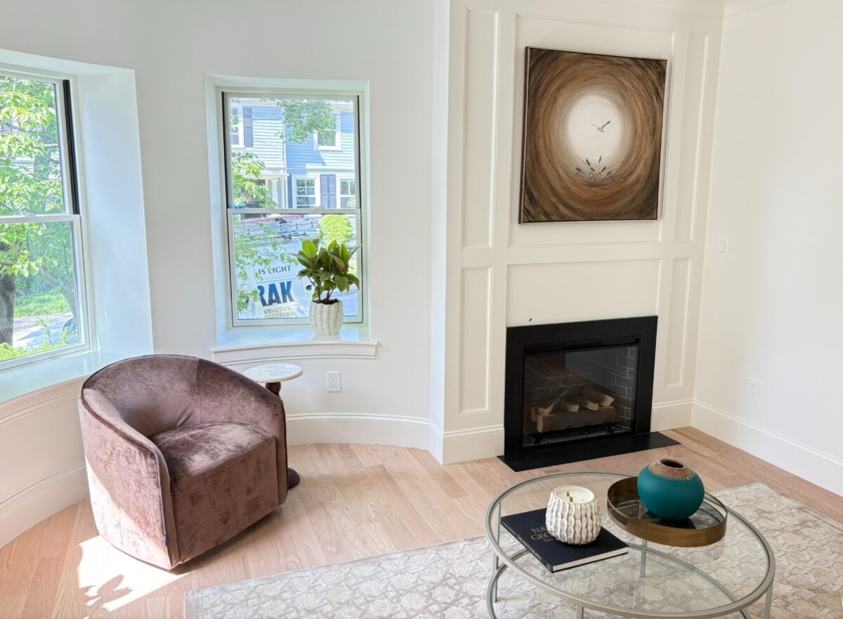 Living room remodel with a corner gas fireplace, hardwood floors and bright bay windows